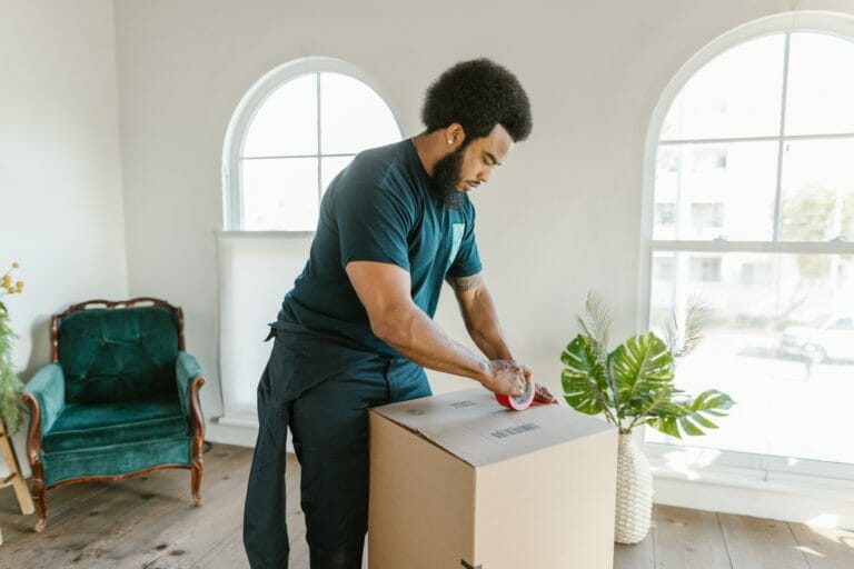Man packing a box when moving house
