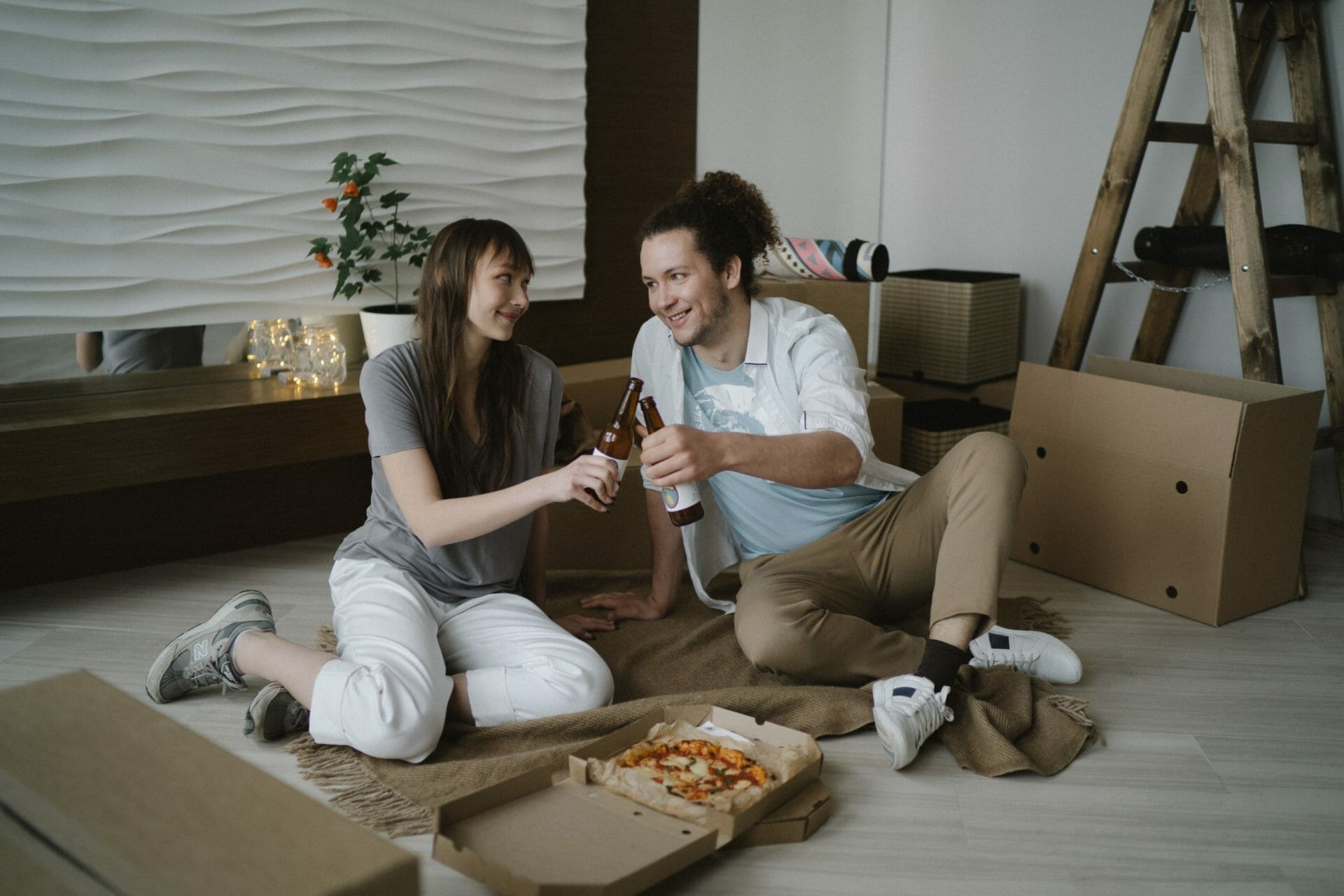 Photo of two people moving into a home